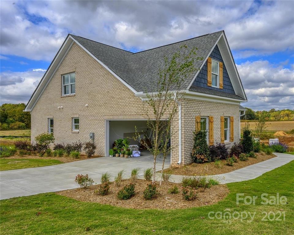 3405 Sincerity Road, Unit 14 Monroe, NC 28110 - Photo 4 of 11 a front view of a house with garden