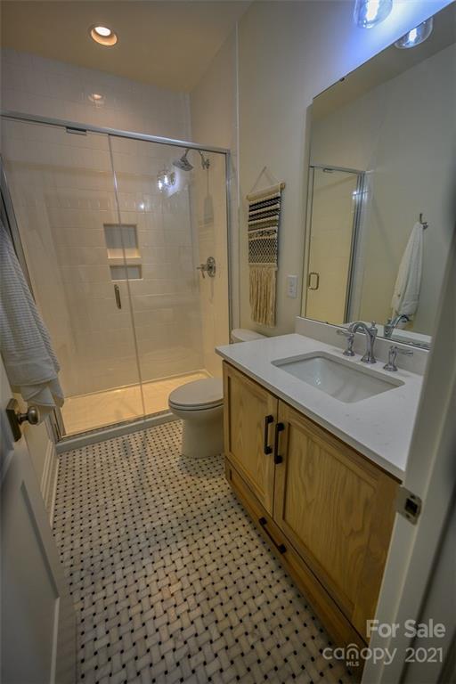 3405 Sincerity Road, Unit 14 Monroe, NC 28110 - Photo 9 of 11 a bathroom with a sink a toilet and shower