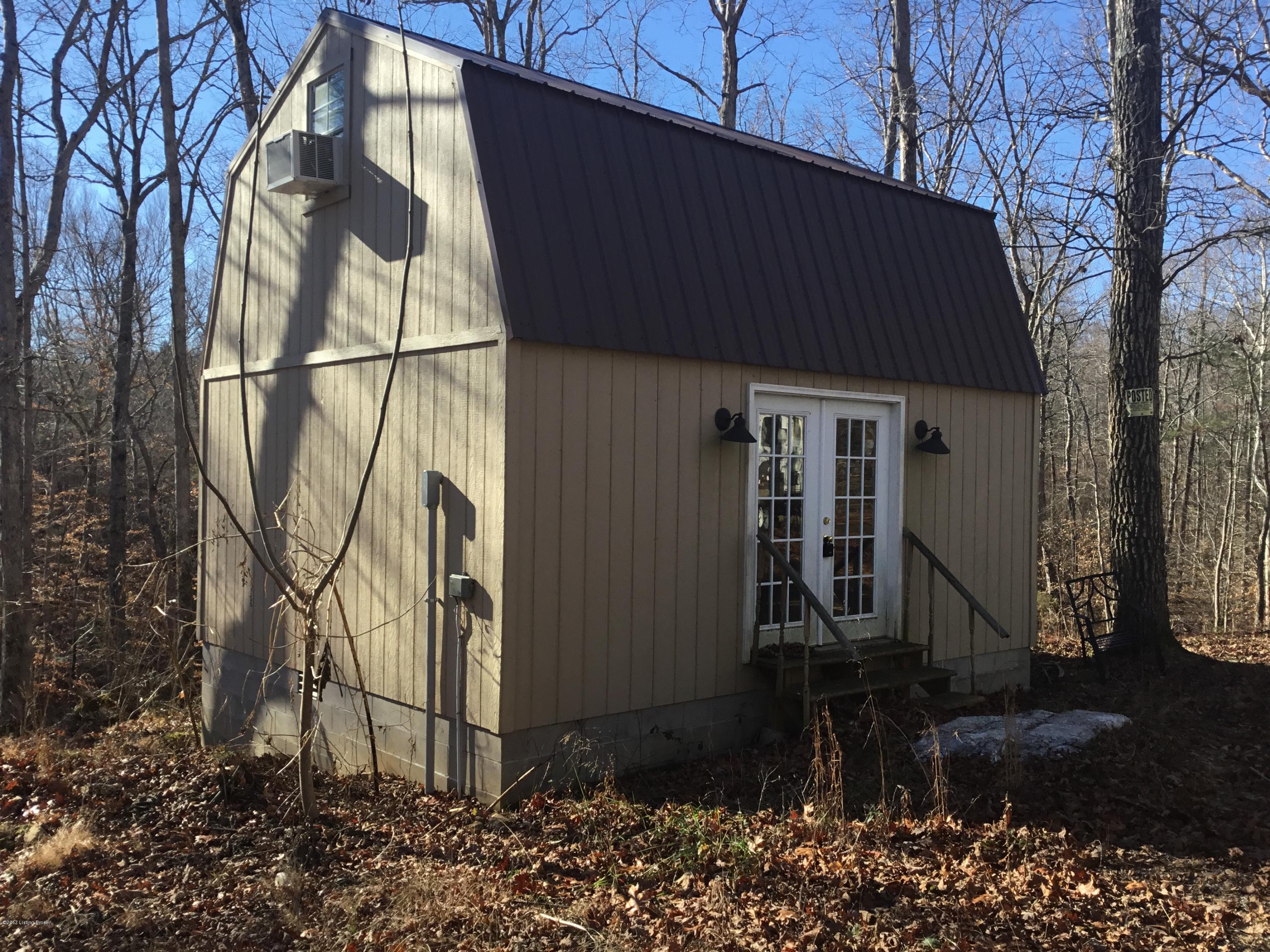 111 Silas Hunt Road Bee Spring, KY 42207 - Photo 1 of 19 Acreage and Cabin is on right before gate in Paradise Peninsula has septic, electric and water. Cabin is not connected to septic system. Camper Trailer does not remain septic is connected to it.