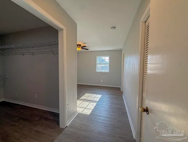 a view of hallway with wooden floor