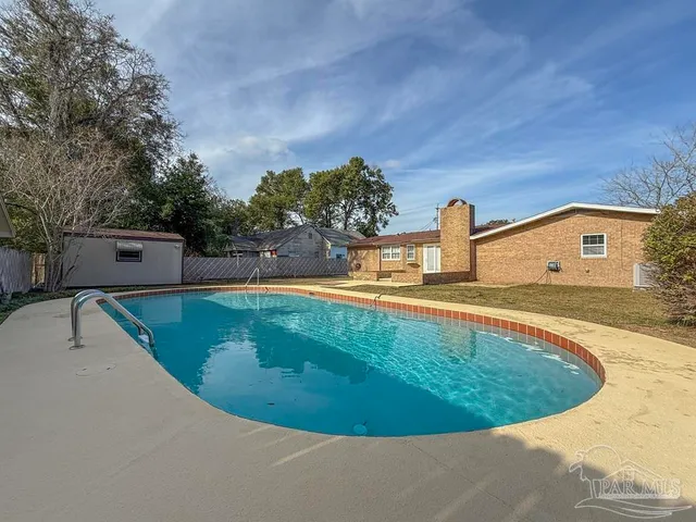 a view of a swimming pool with a yard