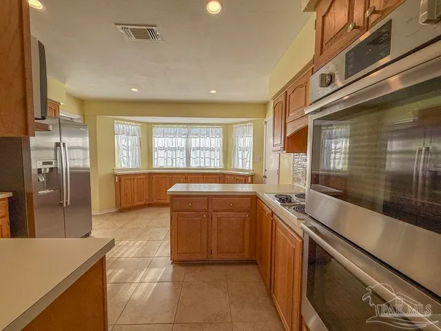 a large kitchen with a large window