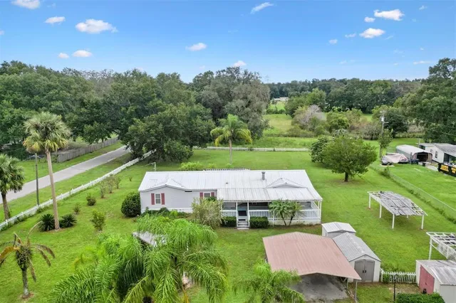 an aerial view of a house with outdoor space and street view