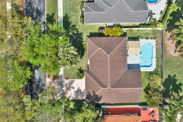 a front view of a house with a garden and yard
