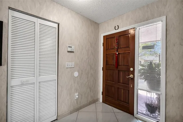 a kitchen with refrigerator and chairs