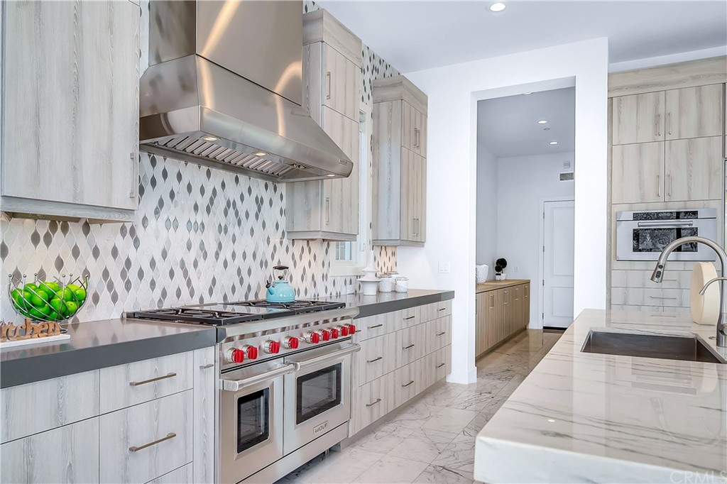 51 Interstellar Irvine, CA 92618 - Photo 12 of 51 a kitchen with stainless steel appliances granite countertop a sink and cabinets