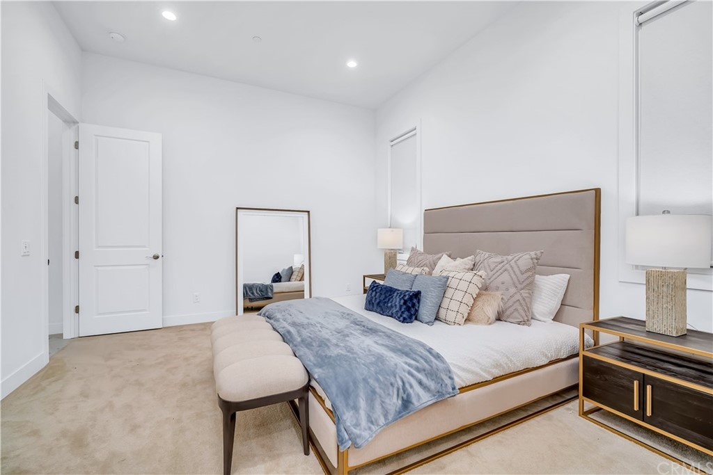 51 Interstellar Irvine, CA 92618 - Photo 17 of 51 a bedroom with a bed and a lamp