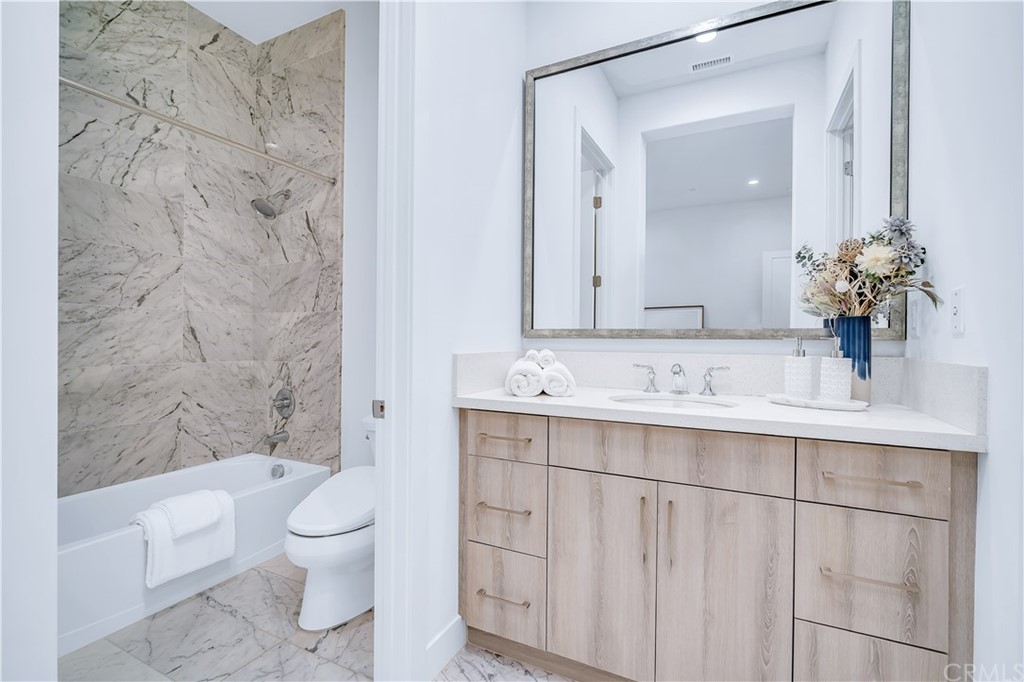 51 Interstellar Irvine, CA 92618 - Photo 18 of 51 a bathroom with a sink a toilet and shower
