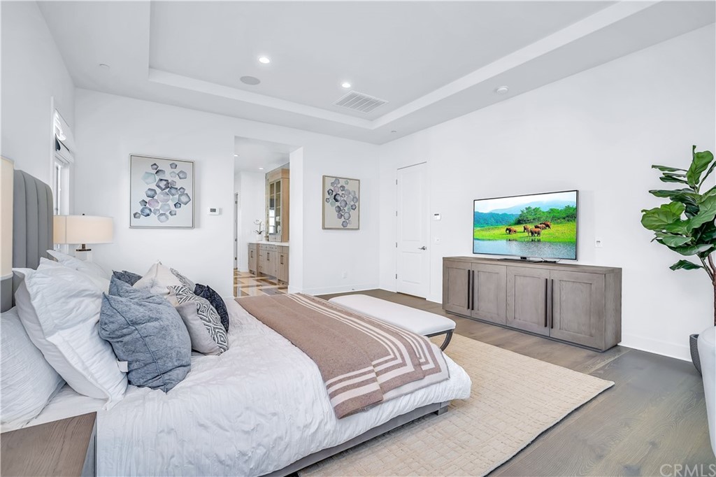 51 Interstellar Irvine, CA 92618 - Photo 27 of 51 a bedroom with a large bed and a flat screen tv
