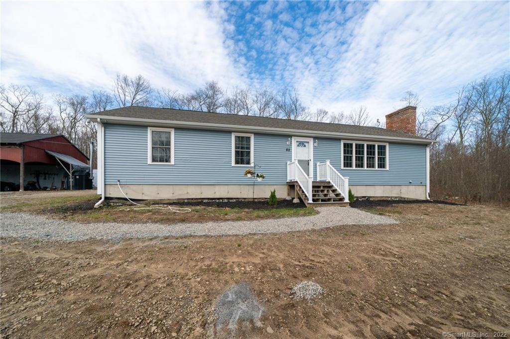82 Nyberg Road Chaplin, CT 06235 - Photo 1 of 1 a backyard of a house with barbeque oven and a tree