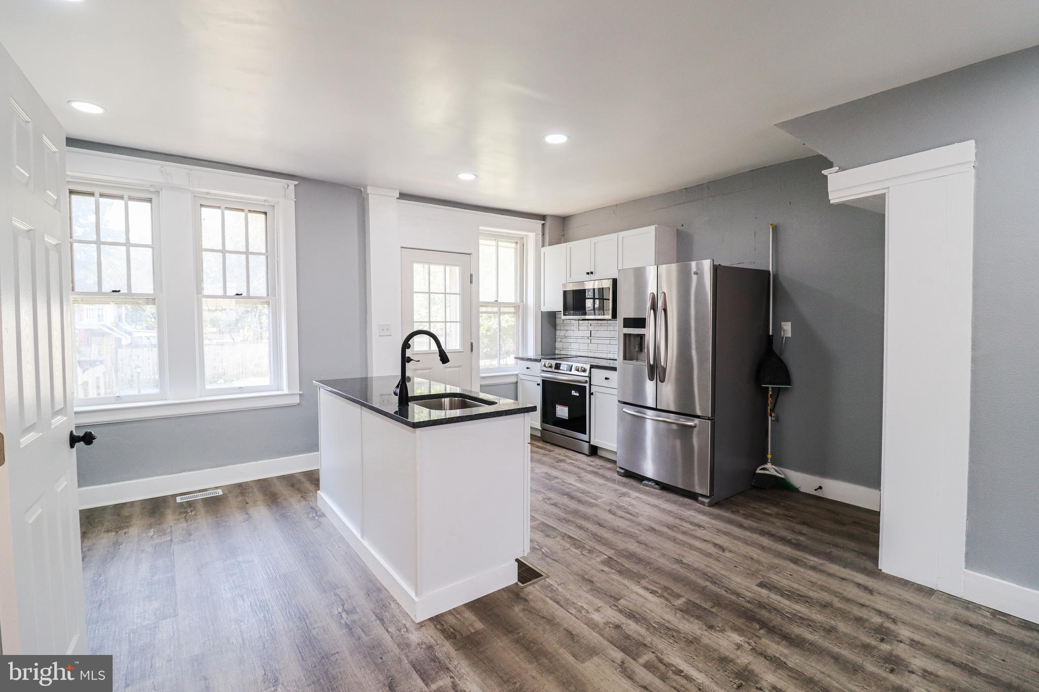 68 South Albemarle Street York, PA 17403 - Photo 7 of 25 a kitchen with a refrigerator a sink and wooden floor