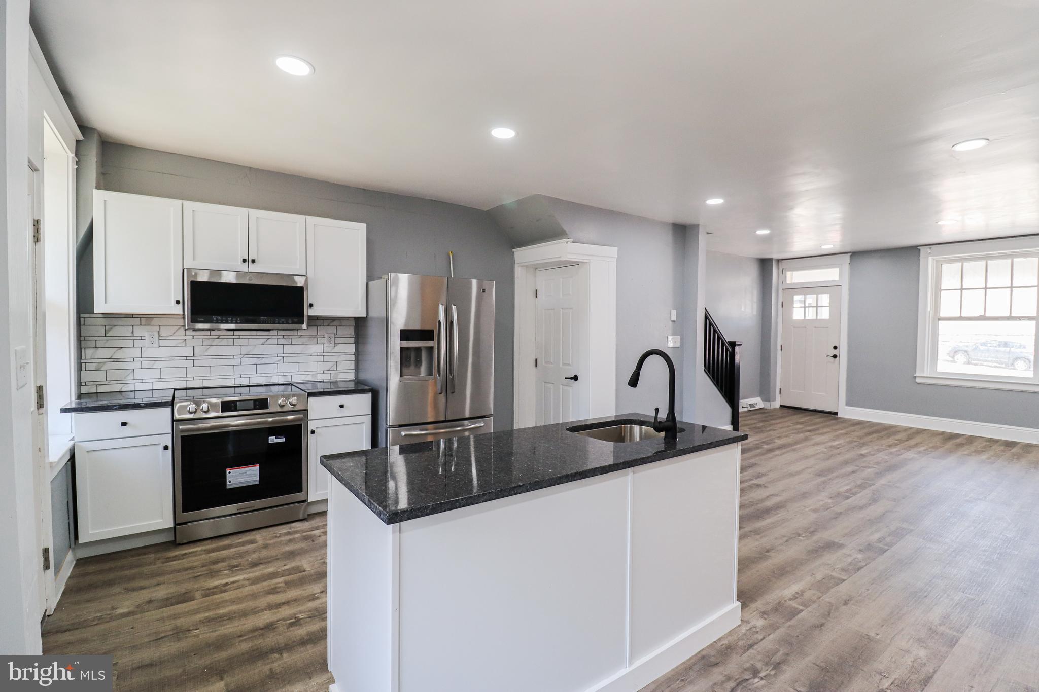 68 South Albemarle Street York, PA 17403 - Photo 8 of 25 a kitchen with granite countertop a sink stove and refrigerator
