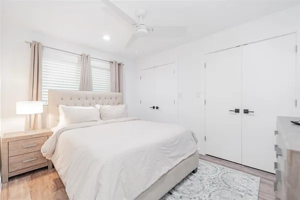 a bedroom with a bed and a window