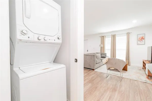 a view of washer and dryer with kitchen in the background