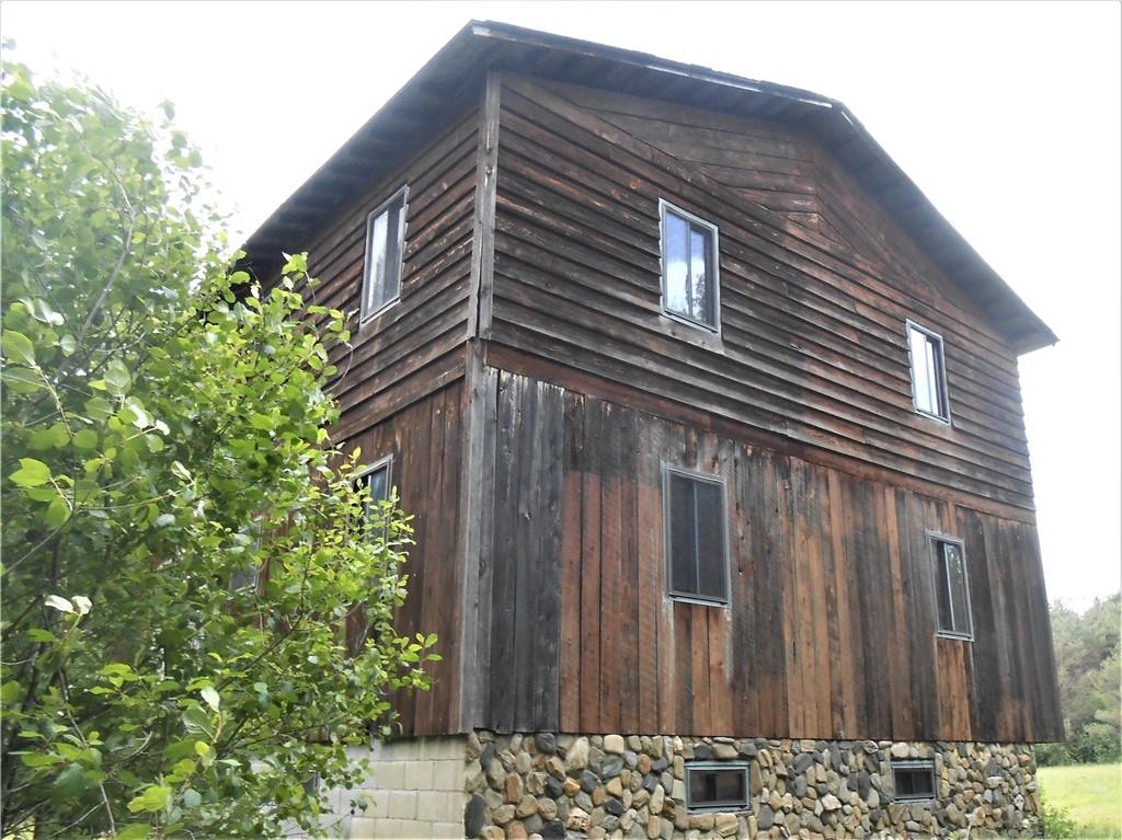 239 Malin Road Ridgway, PA 15853 - Photo 3 of 10 a tall building with a small yard and wooden fence