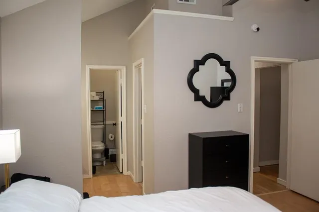 a bedroom with a bed and a mirror