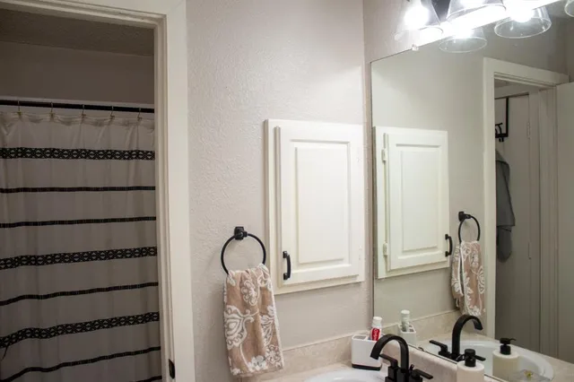 a bathroom with a sink and a mirror