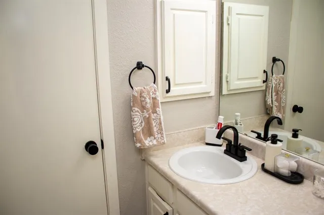a bathroom with a sink and a mirror