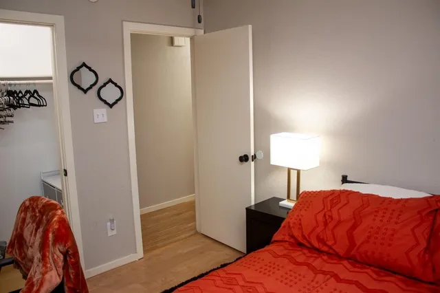 a bedroom with a bed and closet with view