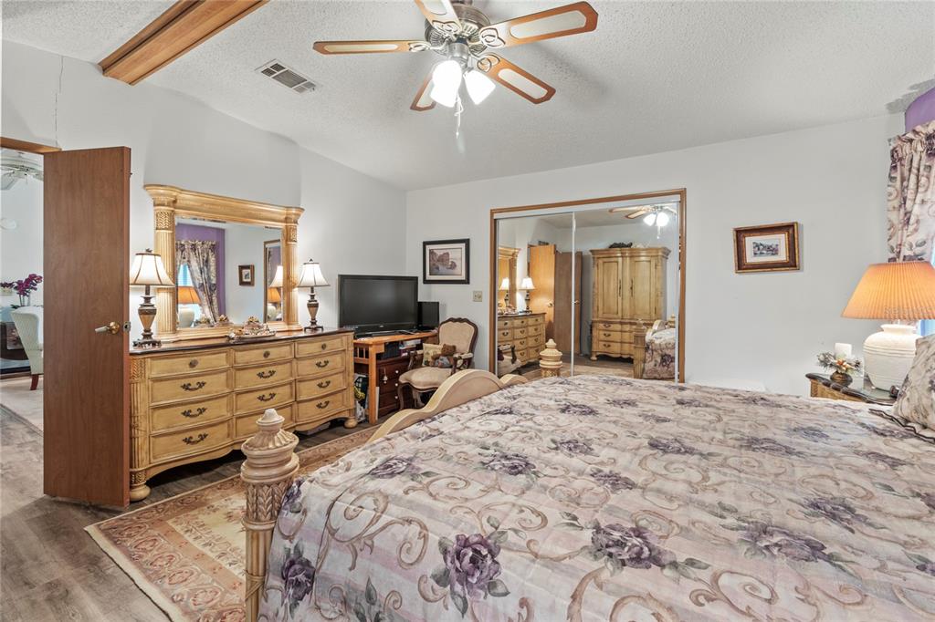 83 Eagle Circle Ellenton, FL 34222 - Photo 27 of 60 a bedroom with a bed and ceiling fan
