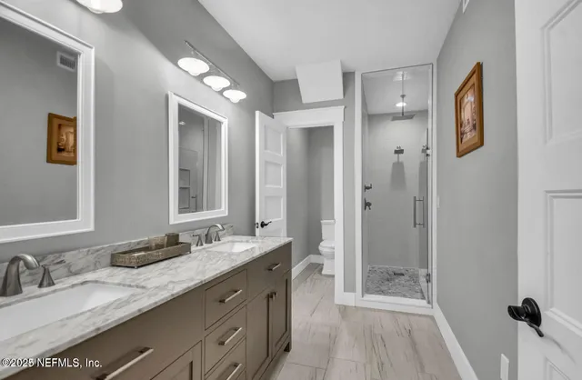 a spacious bathroom with a granite countertop sink mirror and double