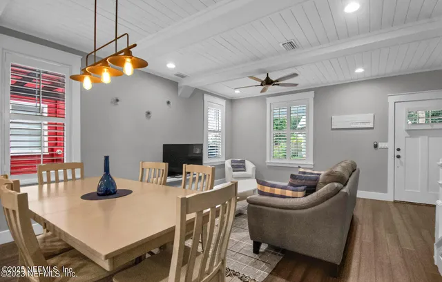 a living room with furniture a window and a flat screen tv