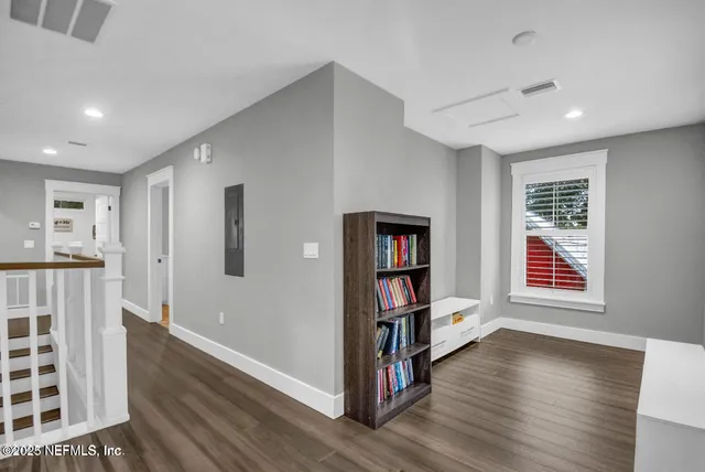 a view of a room with wooden floor closet and windows