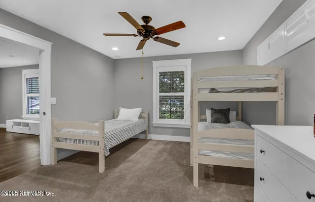 a bedroom with a bed and a ceiling fan