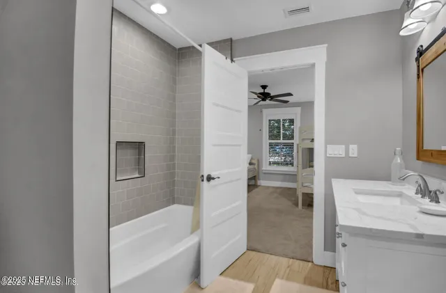 a bathroom with a bathtub and a sink
