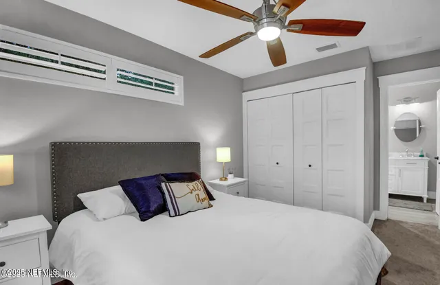 a large bed in a white bedroom