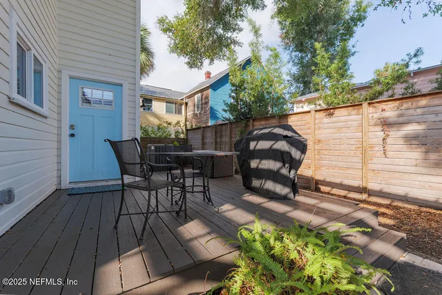 a view of a patio with table and chairs and potted plants