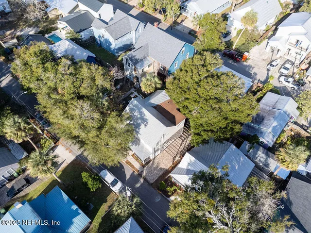 an aerial view of a house with a yard and garden