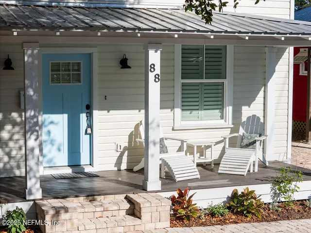 a front view of a house with outdoor seating
