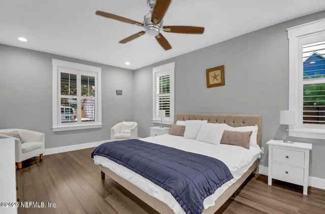 a bedroom with a large bed and a window