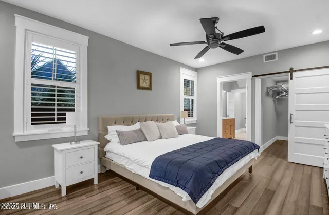 a spacious bedroom with a large bed and a window