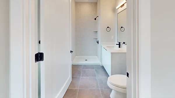 a bathroom with a toilet a sink and shower