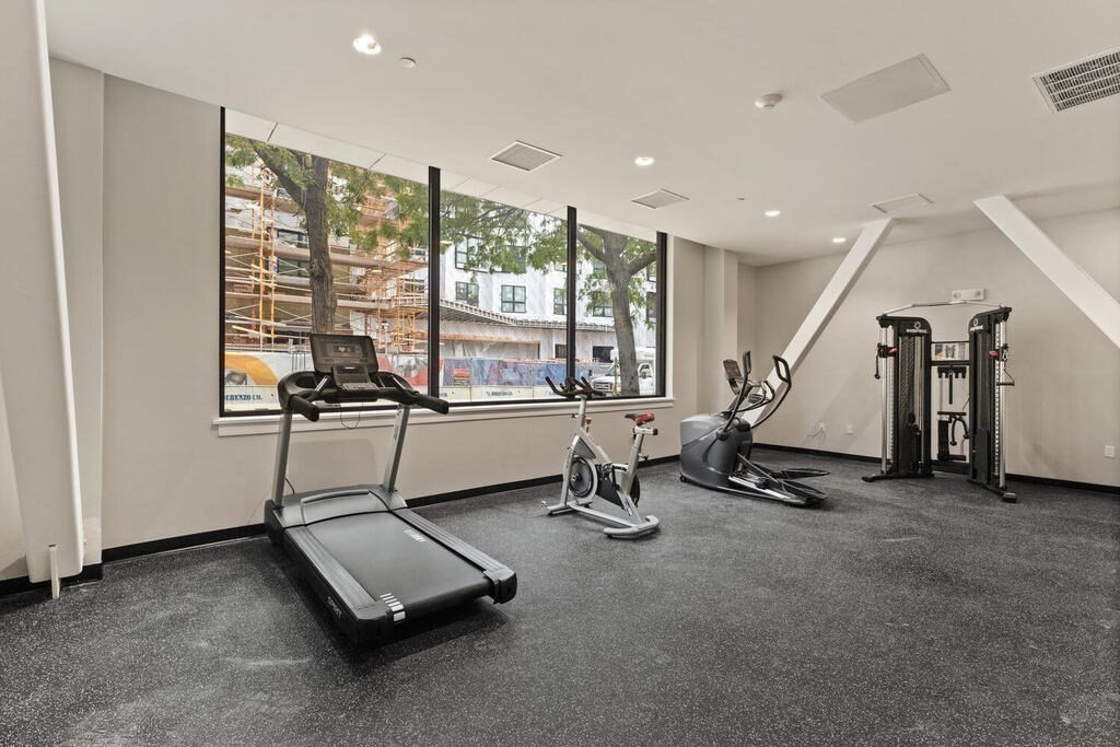 211 Green Street, Unit 509 Boston, MA 02130 - Photo 19 of 20 a room with gym equipment and a large window