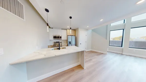 a view of a kitchen with a sink and a large window