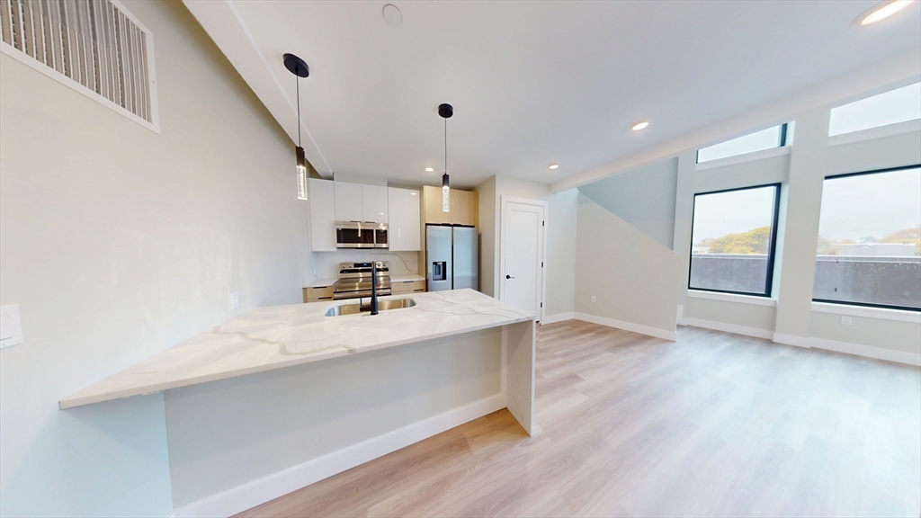 211 Green Street, Unit 509 Boston, MA 02130 - Photo 4 of 20 a view of a kitchen with a sink and a large window