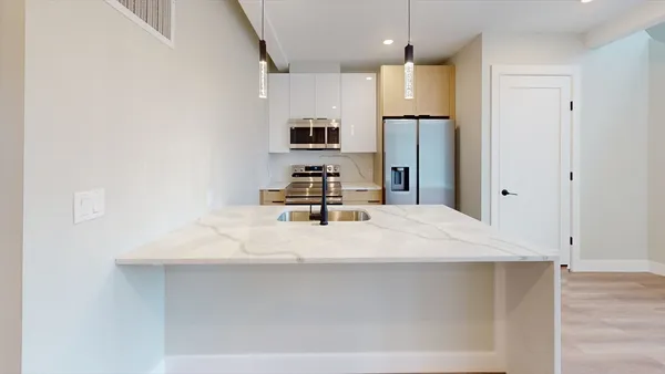 a view of kitchen with wooden floor