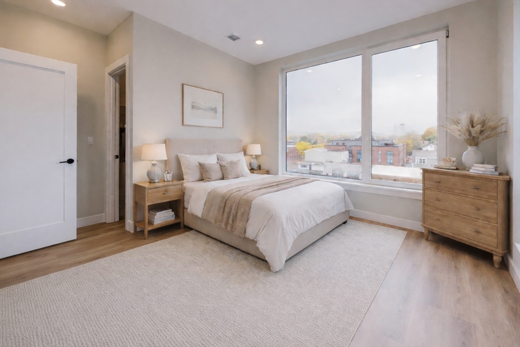 211 Green Street, Unit 509 Boston, MA 02130 - Photo 6 of 20 a bedroom with a bed and a large window