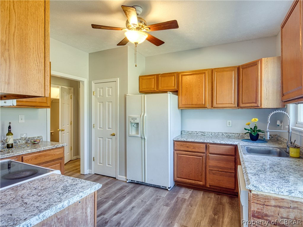 921 Buckley Hall Road Dutton, VA 23050 - Photo 16 of 42 a kitchen with stainless steel appliances granite countertop a sink a stove cabinets and wooden floor