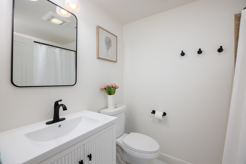 680 Beacon Street Newton, MA 02459 - Photo 17 of 26 a bathroom with a sink vanity mirror and toilet