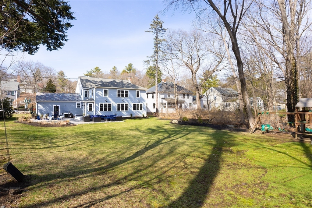 680 Beacon Street Newton, MA 02459 - Photo 23 of 26 a view of a swimming pool with an outdoor seating and a yard