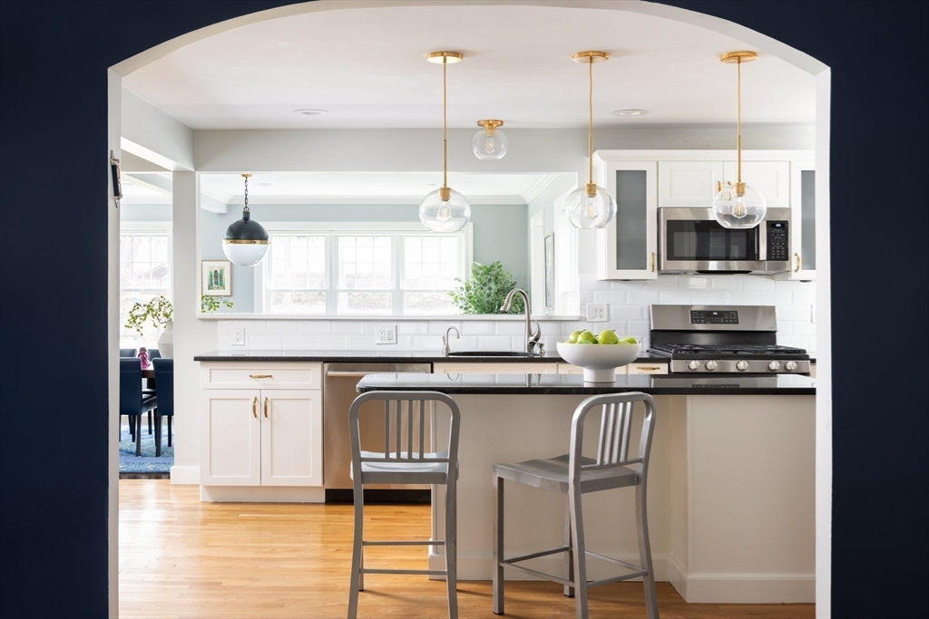 680 Beacon Street Newton, MA 02459 - Photo 8 of 26 a kitchen with granite countertop a stove a sink and a refrigerator