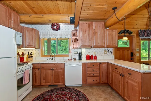a kitchen with a sink window and cabinets