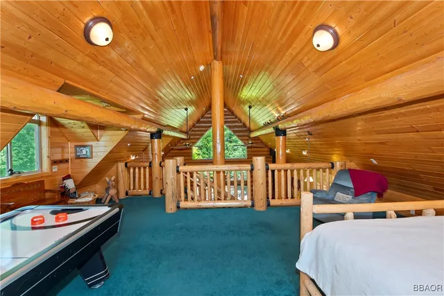 a roof deck with table and chairs and potted plants