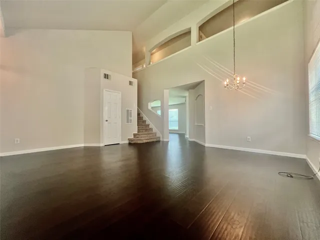 a view of a livingroom with wooden floor and a ceiling fan