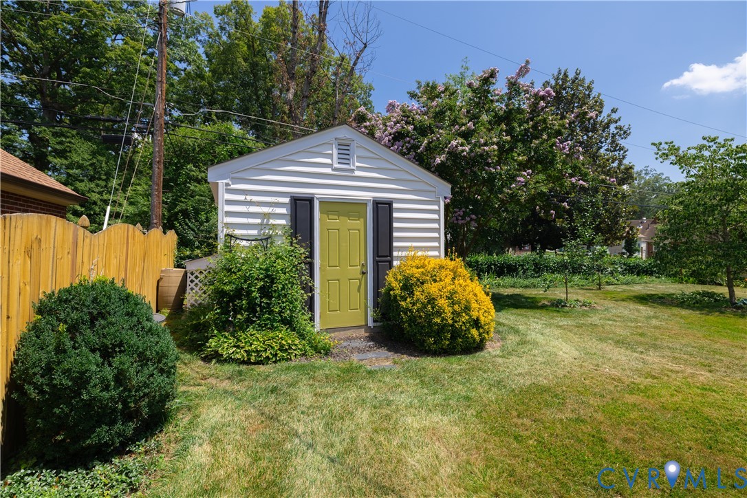 1107 Ridgecrest Drive Henrico, VA 23229 - Photo 21 of 26 Detached shed with horizontal siding, a vibrant gr