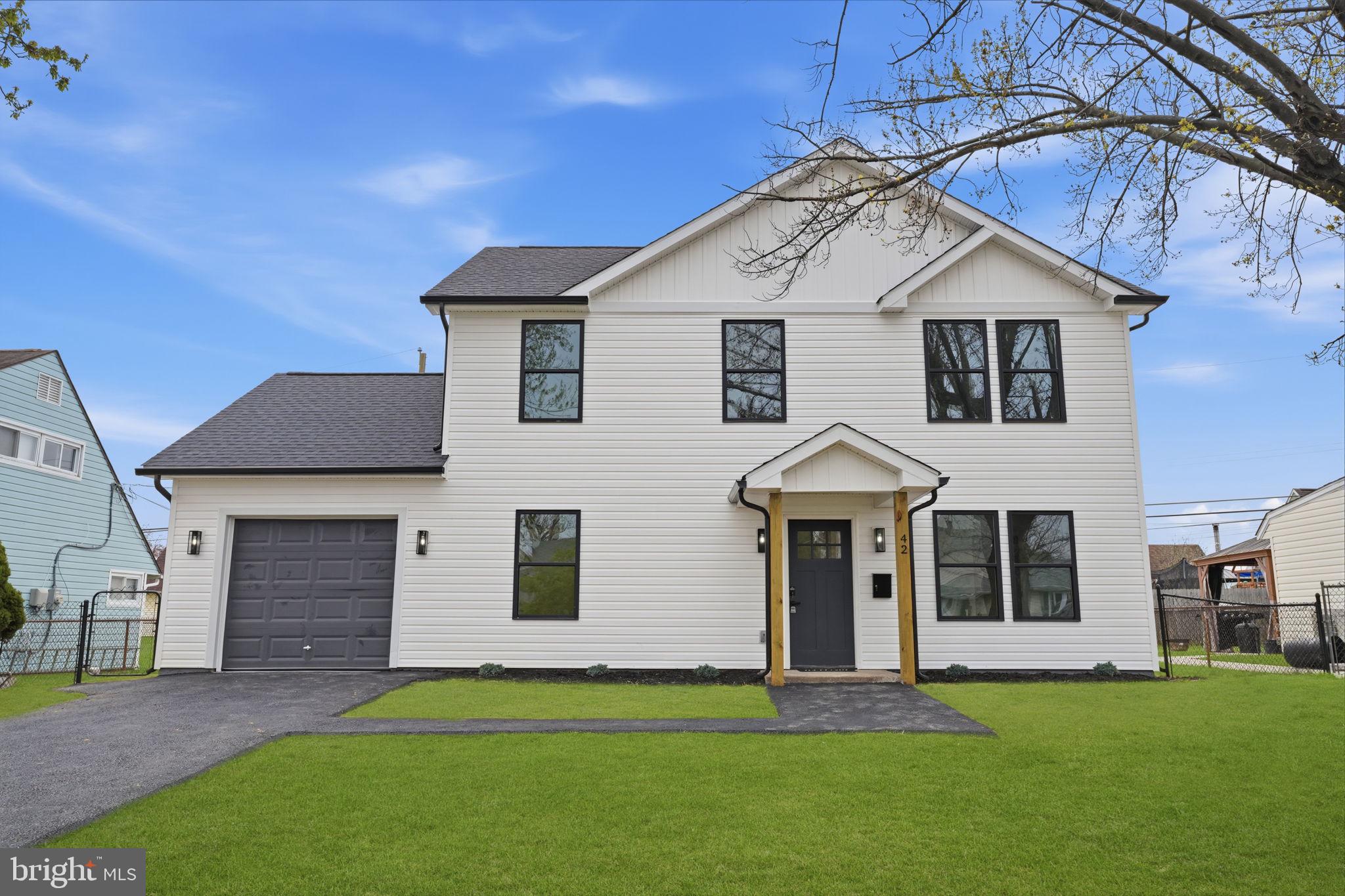14 Inlet Road Levittown, PA 19057 - Photo 2 of 31 a front view of a house with a yard and garage